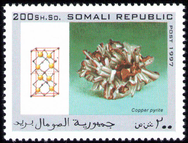 The national postal infrastructure was later completely destroyed during the civil war, with Somali Postal officially suspending operations in October 1991. Postage stamps continued to be produced illegally internationally during the war, although their subject matter suggests they were designed for external collectors. The set of mineral stamps in this album from the Somali republic are examples of hundreds of bogus topical stamps produced up to 2013. The Universal Postal Union is now assisting the reestablished Somali Postal Service to develop its capacity, including providing technical assistance and basic mail processing equipment. In October 2014, the Ministry of Posts and Telecommunications also relaunched postal delivery from abroad. The postal system is slated to be implemented throughout the country via a new postal coding and numbering system. According to the Minister of Posts and Telecommunications Mohamud Ibrihim Adan, the relaunch's next phase will enable local residents to send letters to acquaintances overseas.
Source: https://en.wikipedia.org/wiki/Postage_stamps_and_postal_history_of_Somalia Somali-Republic-1997-Copper Pyrite.jpg