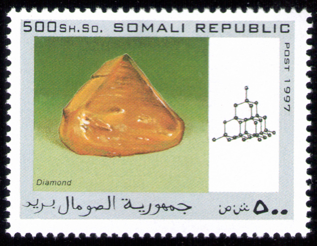 The national postal infrastructure was later completely destroyed during the civil war, with Somali Postal officially suspending operations in October 1991. Postage stamps continued to be produced illegally internationally during the war, although their subject matter suggests they were designed for external collectors. The set of mineral stamps in this album from the Somali republic are examples of hundreds of bogus topical stamps produced up to 2013. The Universal Postal Union is now assisting the reestablished Somali Postal Service to develop its capacity, including providing technical assistance and basic mail processing equipment. In October 2014, the Ministry of Posts and Telecommunications also relaunched postal delivery from abroad. The postal system is slated to be implemented throughout the country via a new postal coding and numbering system. According to the Minister of Posts and Telecommunications Mohamud Ibrihim Adan, the relaunch's next phase will enable local residents to send letters to acquaintances overseas.
Source: https://en.wikipedia.org/wiki/Postage_stamps_and_postal_history_of_Somalia Somali-Republic-1997-Diamond.jpg